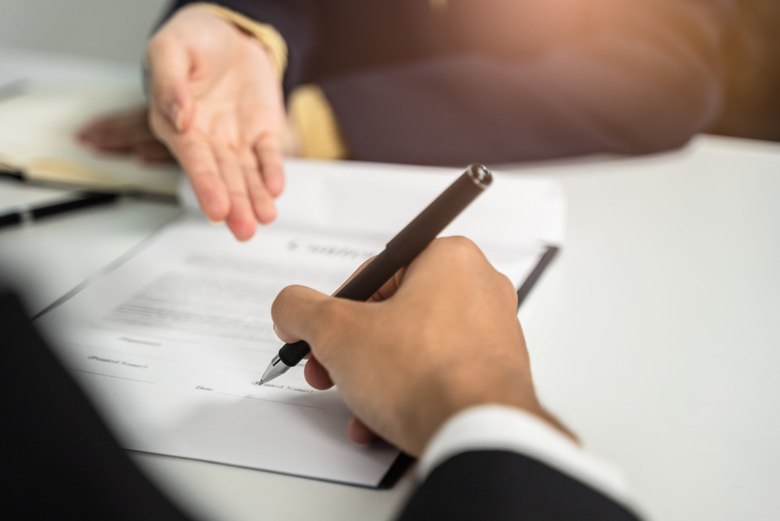 Buyer and seller signing a real estate purchase contract